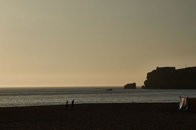 Scenic view of sea against clear sky during sunset