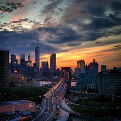 High angle view of brooklyn bridge amidst buildings at sunset