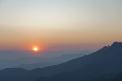 Scenic view of silhouette mountains against sky during sunset