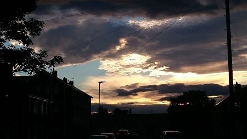 Silhouette buildings against sky during sunset