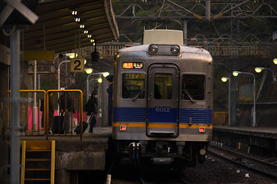 Train at illuminated railroad station