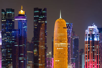 Illuminated buildings of doha city at night