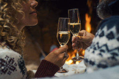 Midsection of woman holding wineglass