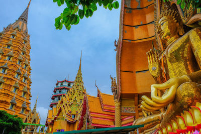 Low angle view of statues on building against sky