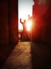 Silhouette man in park during sunset