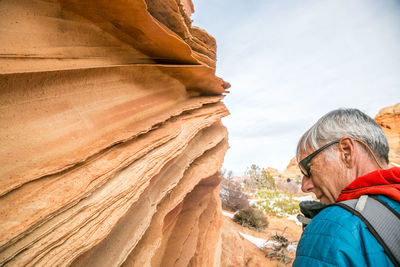 Man contemplates lace rock at south coyote buttes, vermilion cliffs