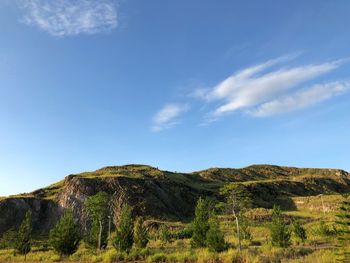 Scenic view of mountains against blue sky