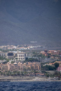 High angle view of buildings against sea