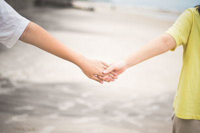 Cropped image of couple holding hands