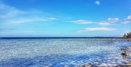 Scenic view of sea against blue sky