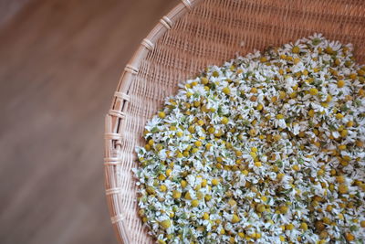 High angle view of chamomiles in wicker bowl