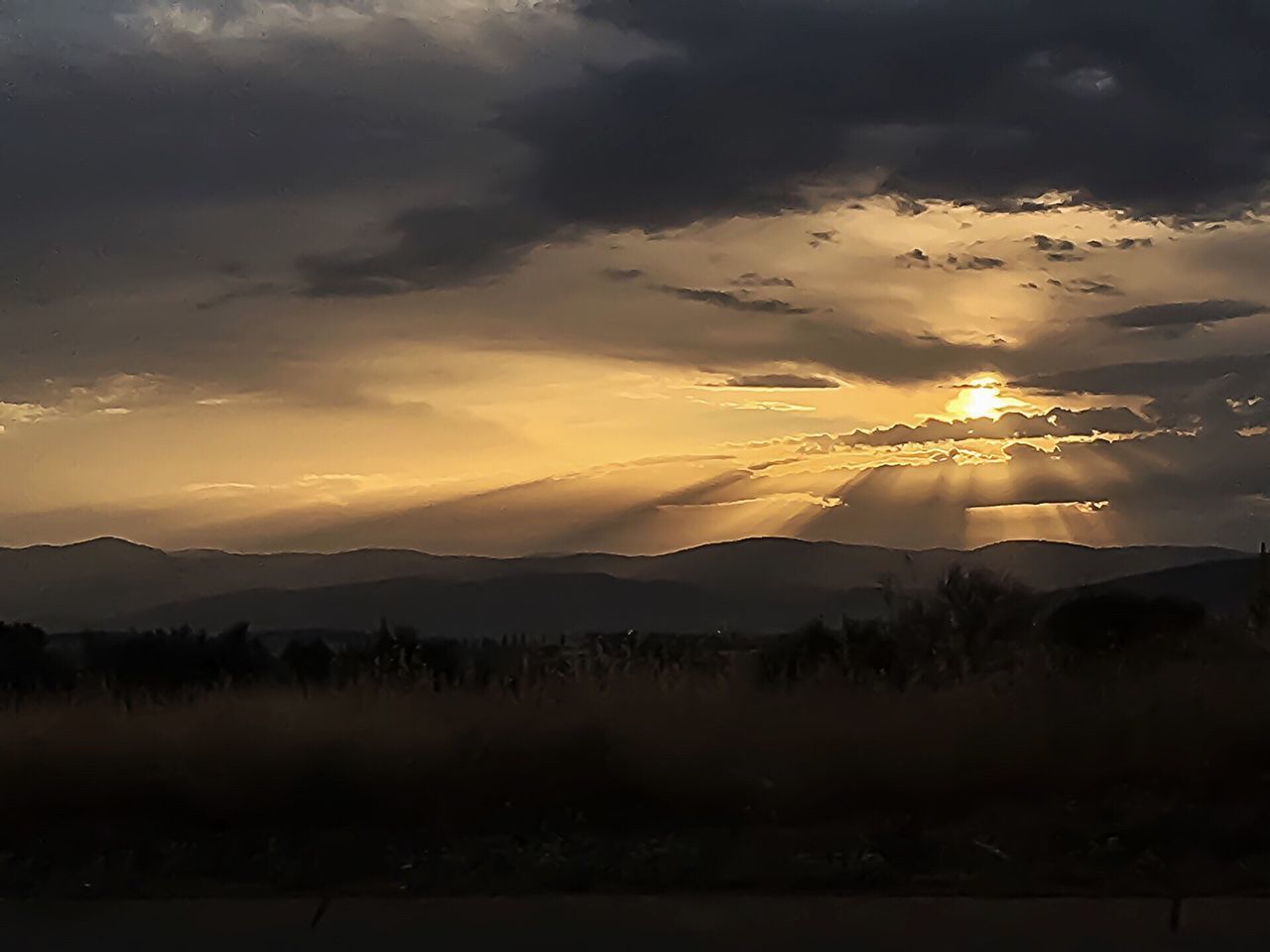 scenics, tranquil scene, sunset, mountain, tranquility, beauty in nature, mountain range, sky, cloud - sky, nature, silhouette, landscape, idyllic, lake, weather, sun, cloud, cloudy, non-urban scene, outdoors