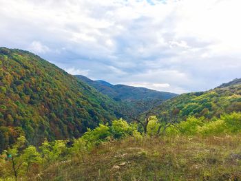 Scenic shot of mountain range against clouds