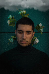 Digital composite image of man wearing flowers during rain