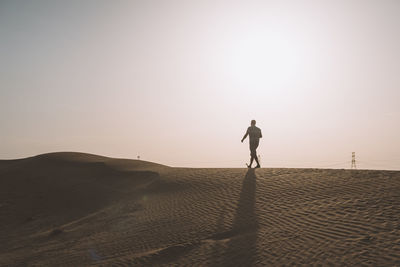 Full length of man on sand at beach against sky