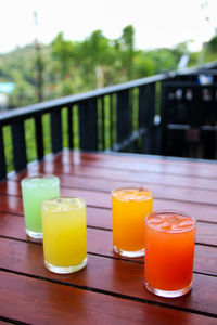 Close-up of yellow and drink on table at swimming pool