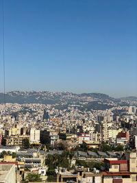 High angle view of townscape against blue sky