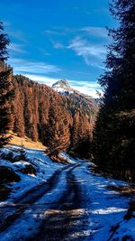 Scenic view of snowcapped mountains against sky during winter