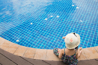 High angle view of woman relaxing in swimming pool