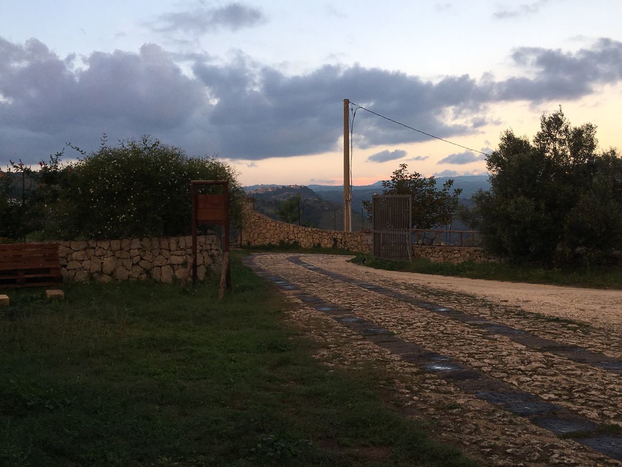 RAILROAD TRACKS ON FIELD AGAINST SKY