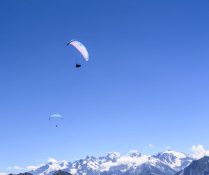 Scenic view of hot air balloons against blue sky