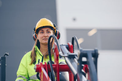 Woman with machinery at construction site