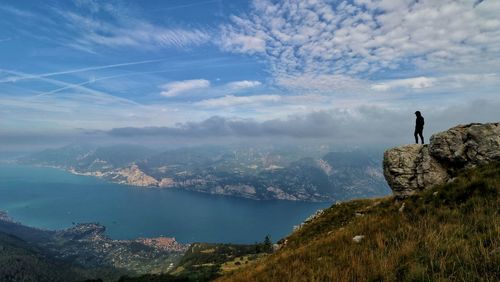 Man standing on mountain against sky