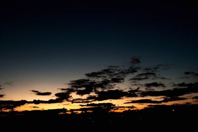 Silhouette trees against sky at night