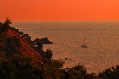 Scenic view of sea against orange sky