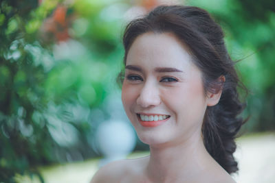 Close-up portrait of smiling young woman