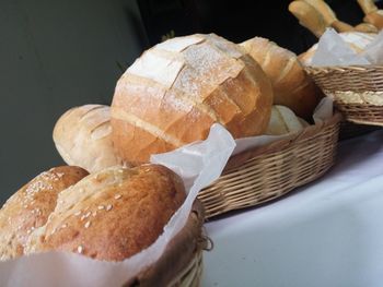 Close-up of homemade breads in wicker basket on table