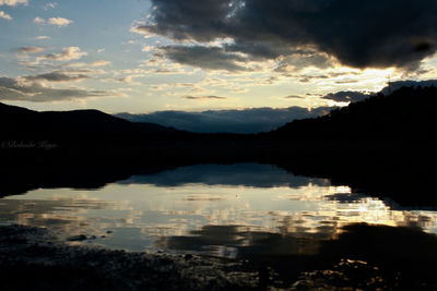 Scenic view of lake against sky during sunset