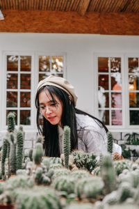 Smiling woman looking at cactus