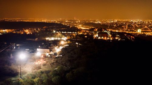 High angle view of illuminated buildings in city at night