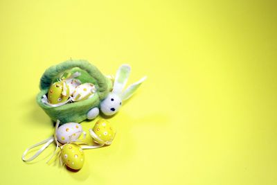 Close-up of stuffed toy over yellow background