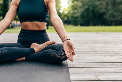 Midsection of woman sitting on floor