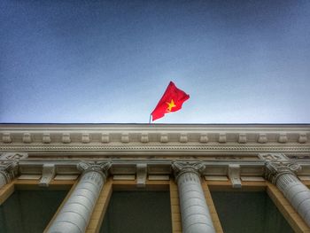 Low angle view of flag against clear sky
