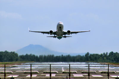 Low angle view of airplane flying against sky