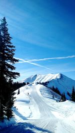 Scenic view of snow covered mountains against sky