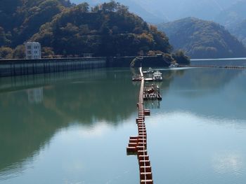 Crane by lake against mountain