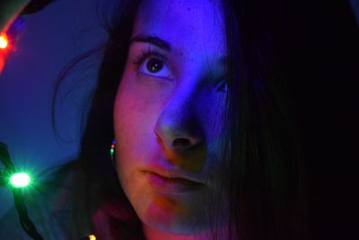 Close-up portrait of young woman looking away