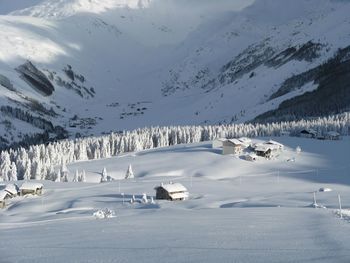 Scenic view of snow covered mountains against sky