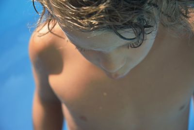 Close-up of shirtless boy at swimming pool