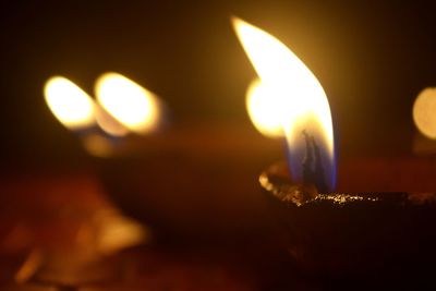 Close-up of lit candles in dark