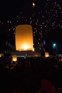 Illuminated street light in city at night