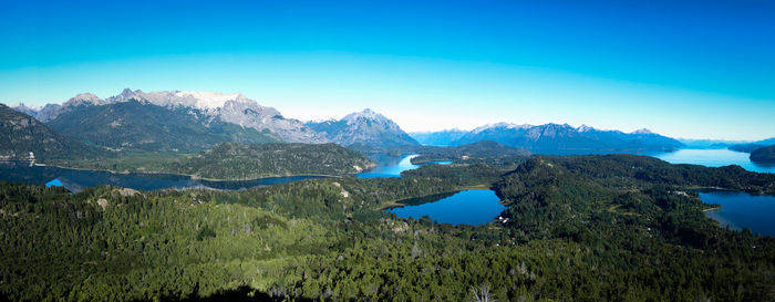 Scenic view of snowcapped mountains against blue sky