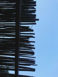 Low angle view of stack against blue sky