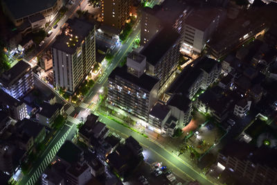 High angle view of city lit up at night