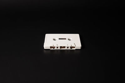 Close-up of vintage car on table against black background