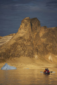 2 men traveling with a sea kayak in eastern greenland